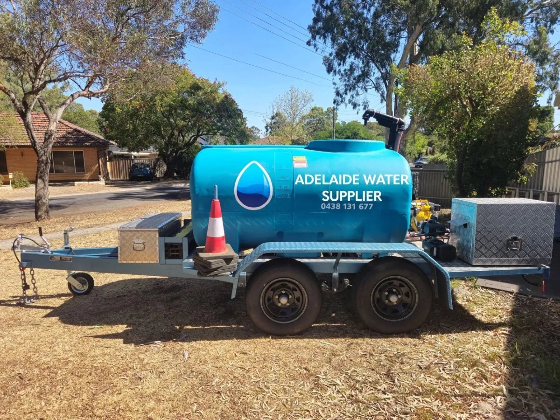 A 2,000 litre water trailer with a blue tank carrying the Adelaide Water Supplier droplet logo and phone number